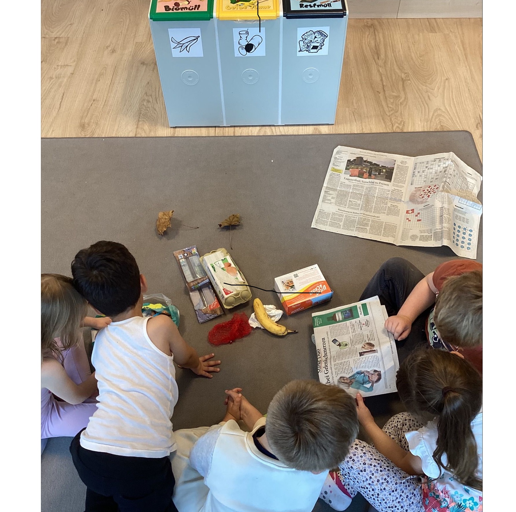 Kinder schauen auf Müll im Gesprächskreis